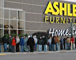 田納西州孟菲斯市Ashley Furniture門口排隊等開門的顧客，一名女士裹著被子禦寒。（攝影：魏毅/大紀元）