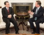 英國首相卡梅倫(右)17日在唐寧街首相府會見到訪的中共政治局常委李長春(左)。卡梅倫敦促中方，「全面而恰當」調查英國商人海伍德在重慶的死亡案件。(LEON NEAL/AFP)