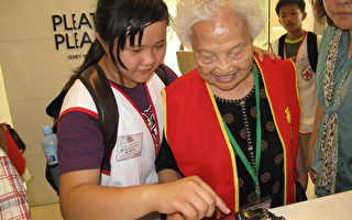中林国小义工教导老长辈操作最新的智慧型手机。  （摄影：苏泰安／大纪元）
