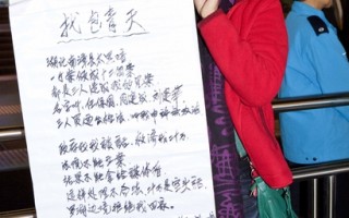 香港访民王艳在港区人大代表选举会场外示威，控诉遭中共迫害的冤情。（摄影：余钢／大纪元）