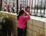 被禁止上学的张安妮隔墙与墙内同学说话 (网友提供)
