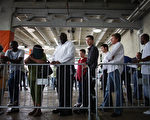 MIAMI, FL - MAY 02:  People looking for work stand in line to apply for a job during a job fair at the Miami Dolphins Sun Life stadium on May 2, 2013 in Miami, Florida. If voters approve a hotel tax hike to fund stadium renovations the jobs would be available. If not, the Dolphins management is indicating they would not be able to renovate the stadium nor create the jobs.  (Photo by Joe Raedle/Getty Images)