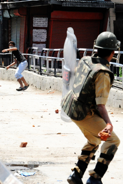 克什米尔，示威者与印度军人互扔砖头。此前印度边防军射杀了4名克什米尔村民。（Rouf BHAT／AFP）