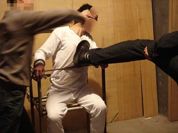 酷刑演示图:警察对被固定着的雷明拳打脚踢。 (明慧网) 酷刑演示图:警察对被固定着的雷明拳打脚踢。 (明慧网)