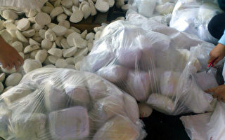 調查局12日召開記者會，宣布破獲近20年最大宗貨櫃走私毒品案，毒梟利用進口大量袋裝冷凍芋頭作掩護，企圖走私大量海洛因磚與K他命毒品。（調查局提供）