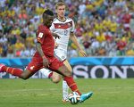 Ghana's forward and captain Asamoah Gyan (L) shoots and scores during a Group G football match between Germany and Ghana at the Castelao Stadium in Fortaleza during the 2014 FIFA World Cup on June 21, 2014.         AFP PHOTO / CARL DE SOUZA        (Photo credit should read CARL DE SOUZA/AFP/Getty Images)
