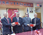 2015年度新一屆主席伍明(右一）、陳庭威（左一）從元老團主席伍煥鵬（右二）、總理譚炳垣（左二）的手中接印宣誓就職。（蔡溶/大紀元）