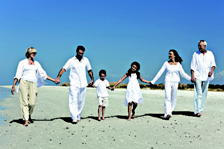 Three Generations of Family Walking Holding Hands on Beach Three Generations of Family Walking Holding Hands on Beach
