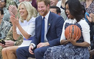 2015年10月28日，英國哈利王子閃電訪問美國，28日在維吉尼亞州貝爾沃堡與美國第一夫人蜜雪兒同為1場輪椅籃球賽充當啦啦隊後，又到華府白宮橢圓形辦公室，拜會美國總統歐巴馬。圖由左到右分別為吉爾·拜登（拜登副總統的妻子）、哈利王子和蜜雪兒。(SAUL LOEB/AFP)