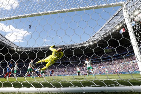 TOPSHOT - France's forward Antoine Griezmann scores a first goal past Ireland's goalkeeper Darren Randolph during the Euro 2016 round of 16 football match between France and Republic of Ireland at the Parc Olympique Lyonnais stadium in Décines-Charpieu, near Lyon, on June 26, 2016. France won the match 2-1. / AFP / Valery HACHE (Photo credit should read VALERY HACHE/AFP/Getty Images)
