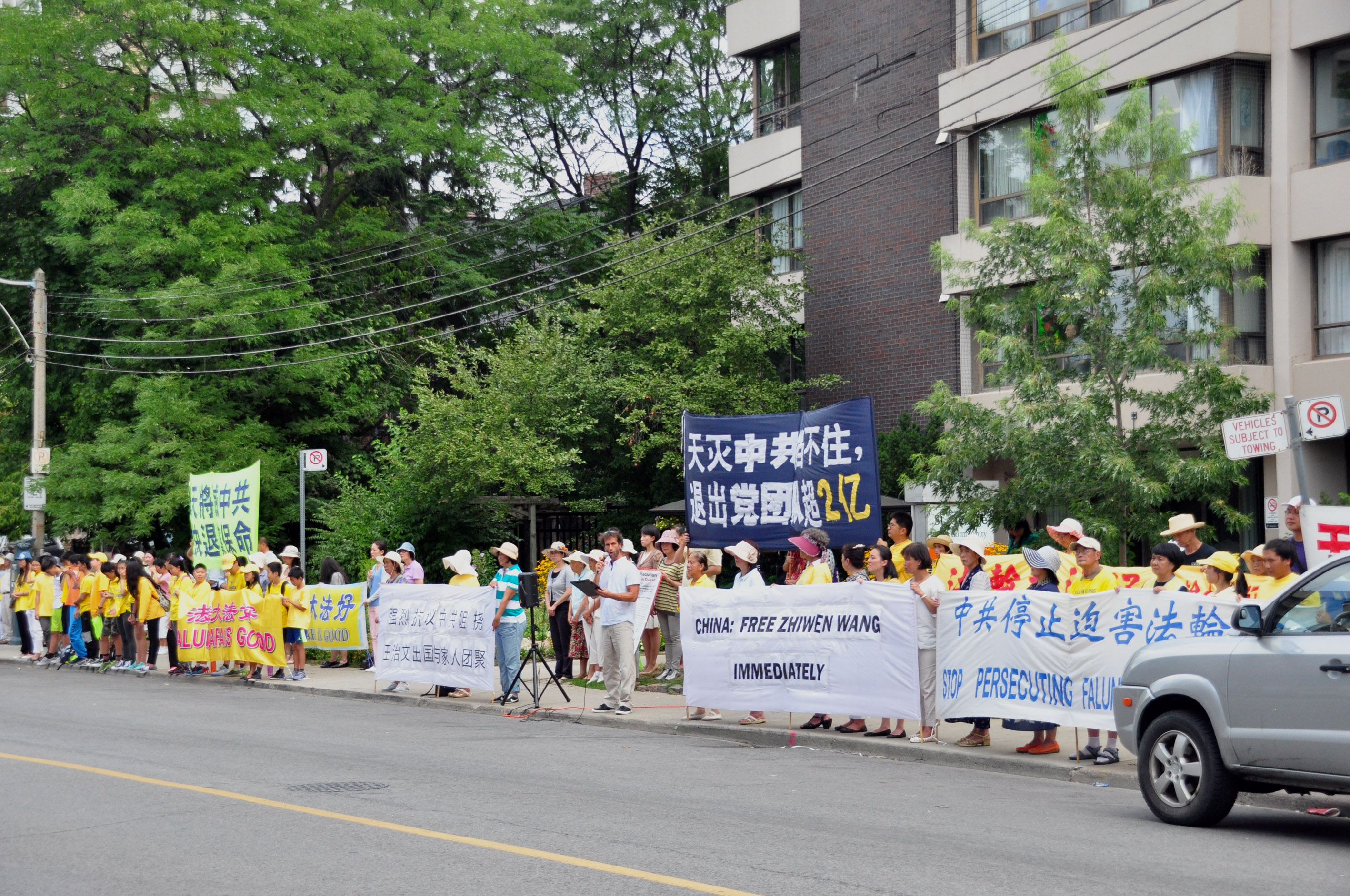 8月12日，近200名法轮功学员和支持者在多伦多中领馆前抗议，呼吁让王治文出国与家人团聚。（周行/大纪元）