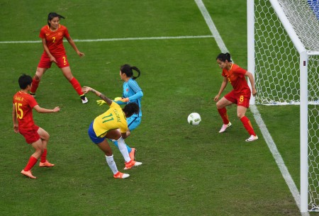 RIO DE JANEIRO, BRAZIL - AUGUST 03: Cristiane of Brazil has her shot blocked by Ruyin Tan of China during the Women's Group E first round match between Brazil and China PR during the Rio 2016 Olympic Games at the Olympic Stadium on August 3, 2016 in Rio de Janeiro, Brazil. (Photo by Shaun Botterill/Getty Images)