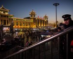 BEIJING, CHINA - FEBRUARY 17:  A Chinese security guard watches over passengers leaving for the Spring Festival at a local railway station on February 17, 2015 in Beijing, China. Millions of Chinese will travel home to visit families in a mass migration during the Spring Festival holiday period that begins with the Lunar New Year on February 19.  (Photo by Kevin Frayer/Getty Images)