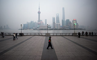 TOPSHOT - A security guard walks at the bund near the Huangpu river across the Pudong New Financial district, in Shanghai on January 18, 2016. China recorded its lowest growth in a quarter of a century in 2015, an AFP survey has forecast, projecting a further slowdown in the world's second-largest economy this year.   AFP PHOTO / JOHANNES EISELE / AFP / JOHANNES EISELE        (Photo credit should read JOHANNES EISELE/AFP/Getty Images)