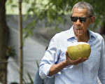 作为首位在任美国总统，美国总统奥巴马在9月6-7日对老挝进行历史性访问，7日结束访问后，奥巴马走在湄公河旁的街道上，试喝椰子水。(SAUL LOEB/AFP/Getty Images)