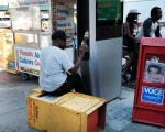 一位遊民正在曼哈頓街頭使用LinkNYC無線上網基站。 (Spencer Platt/Getty Images)