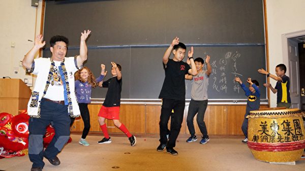 臺灣舞獅技藝會總幹事王宏隆(前左一)在哈佛燕京圖書館傳授舞獅，邀請觀眾上台體驗。(貝拉/大紀元)