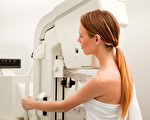 A young woman taking a mammogram x-ray test