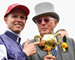 MELBOURNE, AUSTRALIA - NOVEMBER 01:  Jockey Kerrin McEvoy and owner Lloyd Williams pose with the Melbourne Cup after their horse Almandin won race 7, the Emirates Melbourne Cup on Melbourne Cup Day at Flemington Racecourse on November 1, 2016 in Melbourne, Australia.  (Photo by Quinn Rooney/Getty Images)