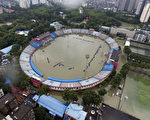 TOPSHOT - This picture taken on July 6, 2016 shows the flooded Xinhua Road Sports Centre Stadium in Wuhan, central China's Hubei province.
Heavy rain around China's Yangtze river basin has left 128 people dead and scores missing, media said on July 5, with more damage feared from a typhoon expected to land this week. / AFP / STR / China OUT        (Photo credit should read STR/AFP/Getty Images)