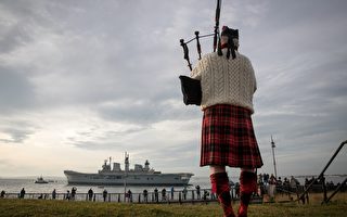 PORTSMOUTH, ENGLAND - DECEMBER 07:  Piper Larry Cunningham plays his bagpipes as Britain's last serving aircraft carrier HMS Illustrious is towed from her home port at Portsmouth Docks after being sold for scrap on December 7, 2016 in Portsmouth, England. The 22,000 tonne ship, whose service started in 1982 in the aftermath of the Falklands War and saw deployments in Bosnia and Sierra Leone, was affectionately known as 'Lusty' and will be broken up for scrap in Turkey despite attempts last minute attempts to save her.  (Photo by Matt Cardy/Getty Images)