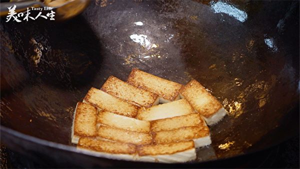 豆腐一翻面 趁熱加鹽(新唐人提供)