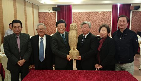 嘉大校长邱义源（左3）特别赠与理事长林国村（右3）亲手雕刻的猫头鹰感谢其对嘉大学子的关怀。（嘉义大学提供）