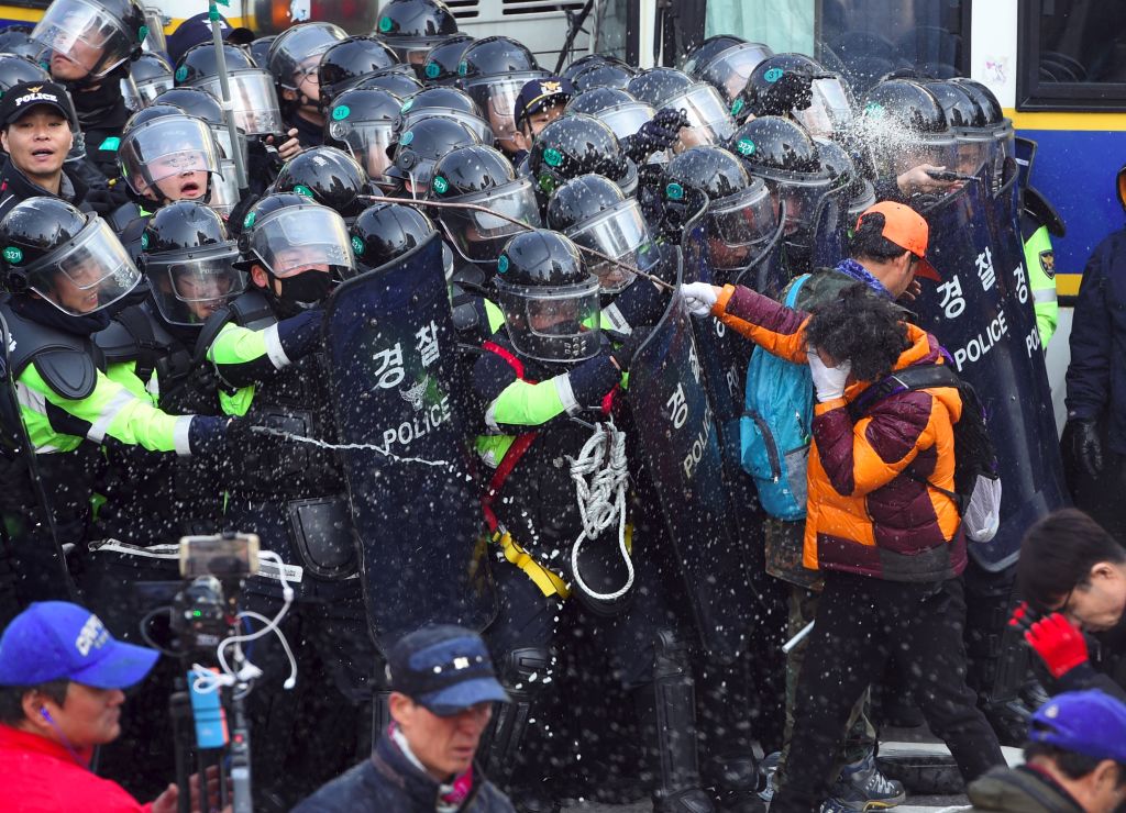 韩国总统朴槿惠的弹劾案确认通过后,场外不同立场的民众爆发冲突,与警察对峙。(Chung Sung-Jun / Getty Images)