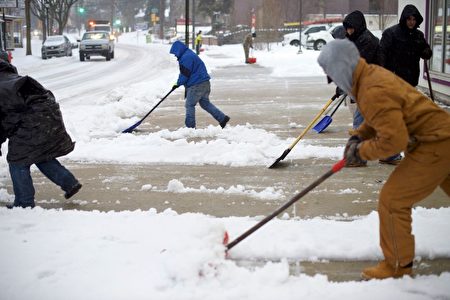 PHILADELPHIA, PA - March 14: Men shovel a sidewalk March 14, 27, 2017 in the Roxborough area of Philadelphia, Pennsylvania. Much of the Northeast is under a state of emergency as a blizzard is expected to bring over one foot of snow and high winds to the area. (Photo by Mark Makela/Getty Images)