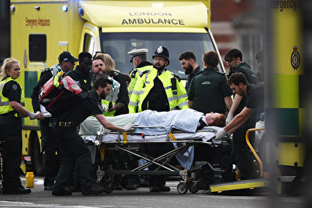 LONDON, ENGLAND - MARCH 22: A member of the public is treated by emergency services near Westminster Bridge and the Houses of Parliament on March 22, 2017 in London, England. A police officer has been stabbed near to the British Parliament and the alleged assailant shot by armed police. Scotland Yard report they have been called to an incident on Westminster Bridge where several people have been injured by a car. (Photo by Carl Court/Getty Images)