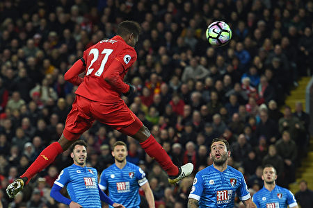 Liverpool's Belgian striker Divock Origi jumps to head their second goal during the English Premier League football match between Liverpool and Bournemouth at Anfield in Liverpool, north west England on April 5, 2017. / AFP PHOTO / PAUL ELLIS / RESTRICTED TO EDITORIAL USE. No use with unauthorized audio, video, data, fixture lists, club/league logos or 'live' services. Online in-match use limited to 75 images, no video emulation. No use in betting, games or single club/league/player publications. / (Photo credit should read PAUL ELLIS/AFP/Getty Images)