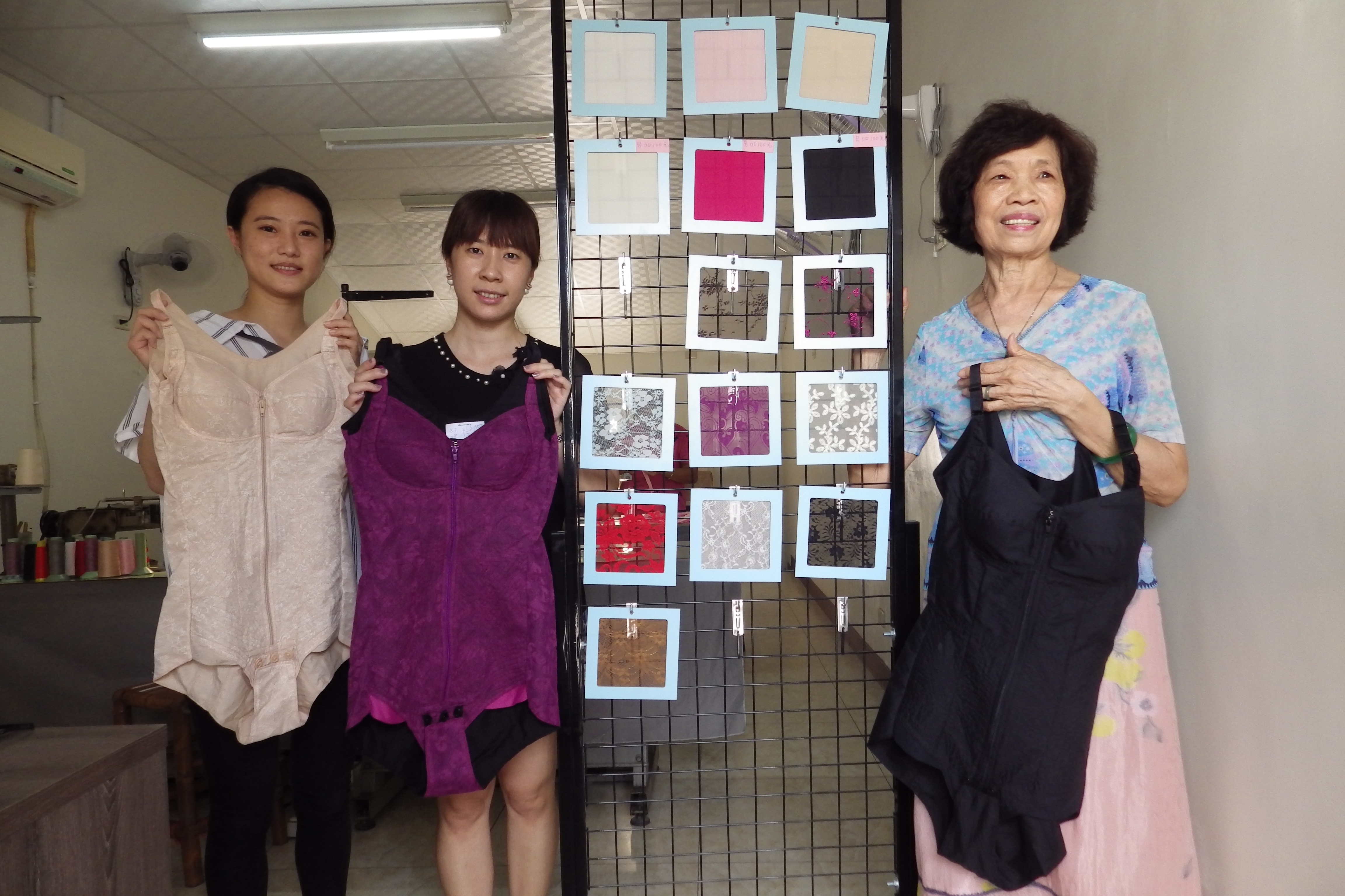 手工塑身內衣達人歐蜜(右)展示她的成品和使用的布料。(廖素貞/大紀元)