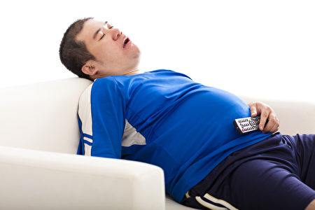 （Fotolia）fat man sleep on the sofa and holding tv remote control