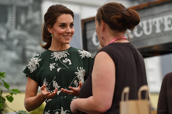 Britain's Catherine, Duchess of Cambridge (L), talks to an exhibitor as she visits the Chelsea Flower Show in London on May 22, 2017. The Chelsea flower show, held annually in the grounds of the Royal Hospital Chelsea, opens to the public this year from May 22. / AFP PHOTO / POOL AND AFP PHOTO / Ben STANSALL (Photo credit should read BEN STANSALL/AFP/Getty Images)