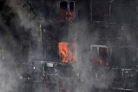6月14日凌晨，倫敦24層的格倫費爾大廈發生大火，整棟公寓樓完全被大火吞噬。圖為消防車進行滅火。(Leon Neal/Getty Images)