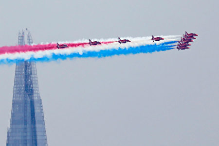 TOPSHOT - Members of the British Royal Air Force Aerobatic Team, the Red Arrows, fly in formation past The Shard skyscraper, as they perform a fly-past above Buckingham Place during the Queen's Birthday Parade, 'Trooping the Colour', in London on June 17, 2017. The ceremony of Trooping the Colour is believed to have first been performed during the reign of King Charles II. In 1748, it was decided that the parade would be used to mark the official birthday of the Sovereign. More than 600 guardsmen and cavalry make up the parade, a celebration of the Sovereign's official birthday, although the Queen's actual birthday is on 21 April. / AFP PHOTO / Tolga AKMEN (Photo credit should read TOLGA AKMEN/AFP/Getty Images)