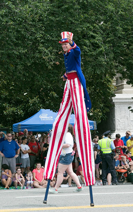 2017年华府国家独立日大游行。身穿红白蓝色服装的表演者在踩高跷。（李莎／大纪元）