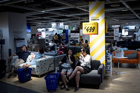 This picture taken on July 5, 2017 shows people escaping the summer heat by relaxing on a sofa in a Ikea store in downtown Shanghai. According to a local news paper Shanghai Meteorological Bureau recorded a temperature high of high of 36.2 degrees Celsius during that time. / AFP PHOTO / Johannes EISELE (Photo credit should read JOHANNES EISELE/AFP/Getty Images)