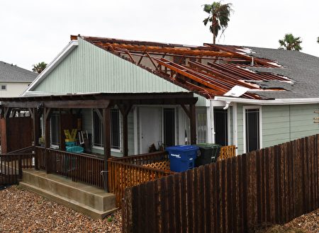 A house suffers roof damage after Hurricane Harvey hit Corpus Christi, Texas on August 26, 2017. Hurricane Harvey slammed into the Texas coast late Friday, unleashing torrents of rain and packing powerful winds, the first major storm to hit the US mainland in 12 years. / AFP PHOTO / MARK RALSTON (Photo credit should read MARK RALSTON/AFP/Getty Images)