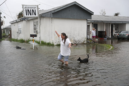 ROCKPORT, TX - AUGUST 26: Valerie Brown walks through a flooded area after leaving the apartment that she road out Hurricane Harvey in on August 26, 2017 in Rockport, Texas. Harvey made landfall shortly after 11 p.m. Friday, just north of Port Aransas as a Category 4 storm and is being reported as the strongest hurricane to hit the United States since Wilma in 2005. Forecasts call for as much as 30 inches of rain to fall in the next few days. (Photo by Joe Raedle/Getty Images)