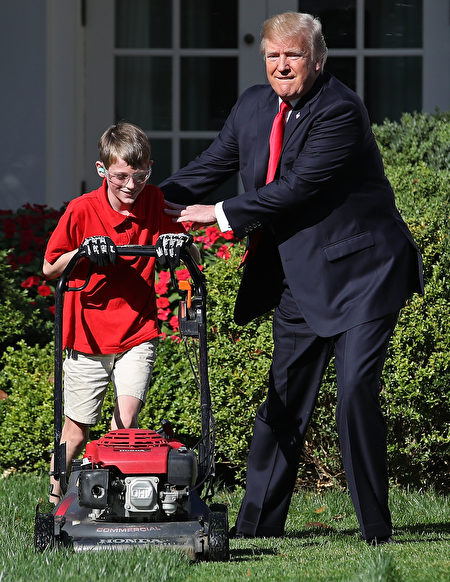 2017年9月15日上午，美國總統川普在白宮的玫瑰花園和11歲的維吉尼亞州男孩弗蘭克一起修剪草坪。(Win McNamee/Getty Images) 