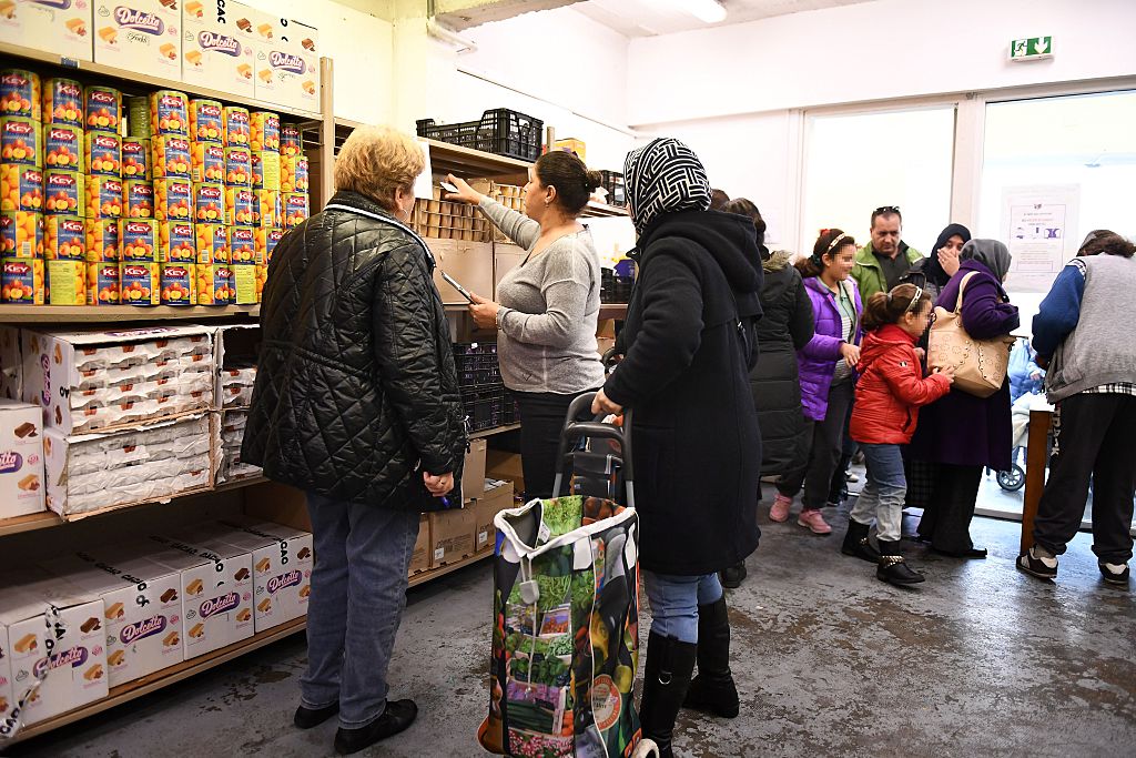 貧困者正在愛心食堂向志願者領取食物。 (ANNE-CHRISTINE POUJOULAT/AFP/Getty Images)