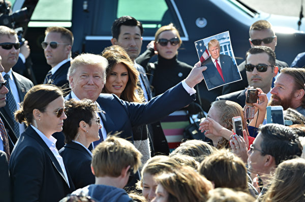 TOPSHOT - US President Donald Trump (C-L) and his wife Melania (C-R) are welcomed upon arriving at Yokota Air Base in Tokyo on November 5, 2017. Trump touched down in Japan, kicking off the first leg of a high-stakes Asia tour set to be dominated by soaring tensions with nuclear-armed North Korea. / AFP PHOTO / POOL / Kazuhiro NOGI (Photo credit should read KAZUHIRO NOGI/AFP/Getty Images)