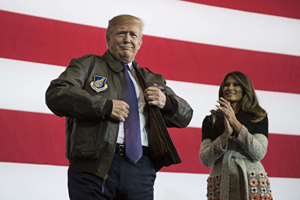 TOPSHOT - US President Donald Trump (R) prepares to addresse US soldiers as his wife Melania looks on upon arriving at US Yokota Air Base in Tokyo on November 5, 2017. Trump touched down in Japan, kicking off the first leg of a high-stakes Asia tour set to be dominated by soaring tensions with nuclear-armed North Korea. / AFP PHOTO / JIM WATSON (Photo credit should read JIM WATSON/AFP/Getty Images)