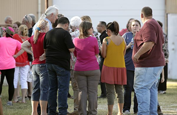 SUTHERLAND SPRINGS, TX - NOVEMBER 5: People gather near First Baptist Church following a shooting on November 5, 2017 in Sutherland Springs, Texas. At least 26 people were reportedly killed and 24 injured when a gunman, identified as Devin P. Kelley, 26, allegedly entered the church during a service and opened fire. (Photo by Erich Schlegel/Getty Images)