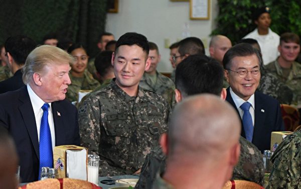 聊天階段，坐在兩位總統中間的這位韓國士兵很活潑。(JIM WATSON/AFP/Getty Images)