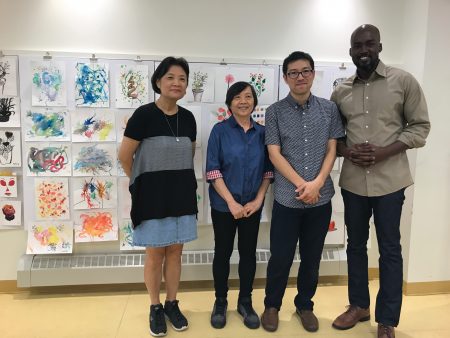 皇后區藝術協會（QCA）的經理Molaundo Jones（右一）、繪畫班老師蕭喆旻（右二）與繪畫班學員在學員畫作前。
