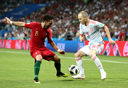 SOCHI, RUSSIA - JUNE 15: Andres Iniesta of Spain challenge for the ball with Joao Moutinho of Portugal during the 2018 FIFA World Cup Russia group B match between Portugal and Spain at Fisht Stadium on June 15, 2018 in Sochi, Russia. 