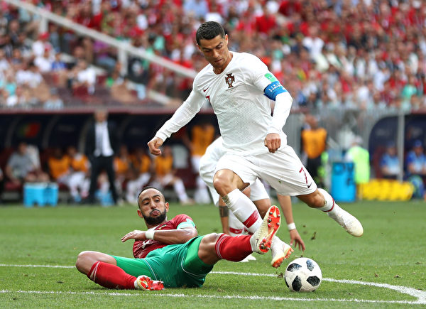 MOSCOW, RUSSIA - JUNE 20: Cristiano Ronaldo of Portugal is fouled by Mehdi Benatia of Morocco just outside the box during the 2018 FIFA World Cup Russia group B match between Portugal and Morocco at Luzhniki Stadium on June 20, 2018 in Moscow, Russia. 