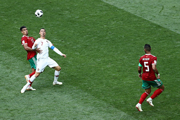 MOSCOW, RUSSIA - JUNE 20: Nabil Dirar of Morocco tackles Cristiano Ronaldo of Portugal during the 2018 FIFA World Cup Russia group B match between Portugal and Morocco at Luzhniki Stadium on June 20, 2018 in Moscow, Russia.